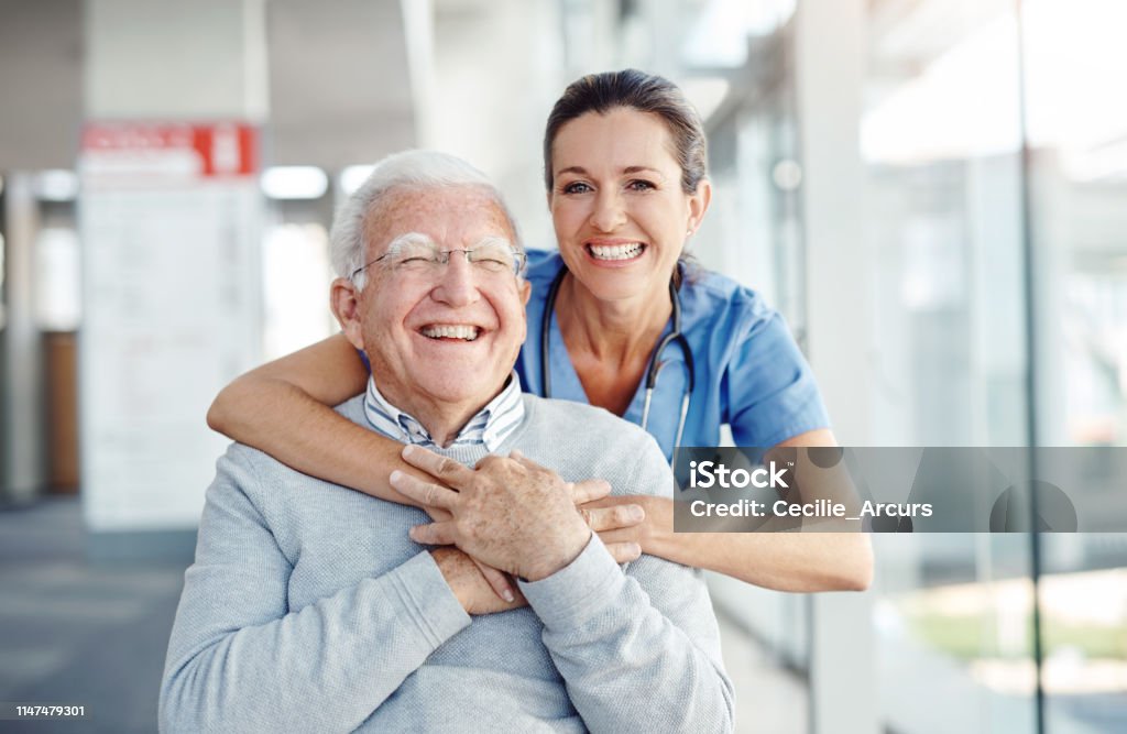 Cropped shot of a female nurse embracing her patient from behind